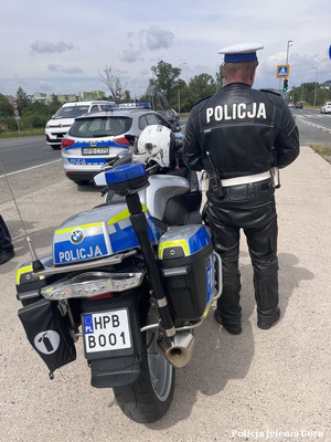 policjant, w tle motocykl