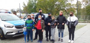 Policjanci rozmawiają z dziećmi o bezpieczeństwie i zagrożeniach.